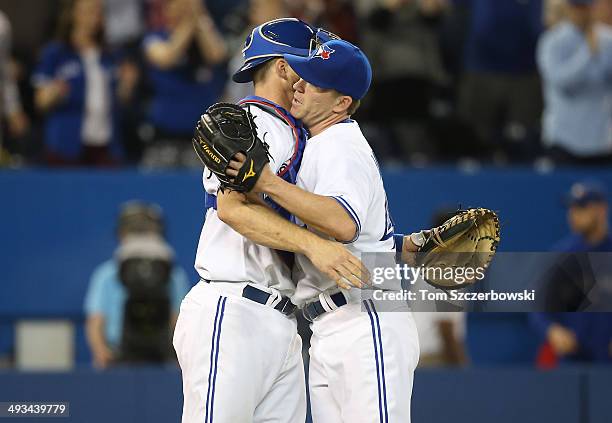 Casey Janssen of the Toronto Blue Jays celebrates the victory with Erik Kratz during MLB game action against the Oakland Athletics on May 23, 2014 at...