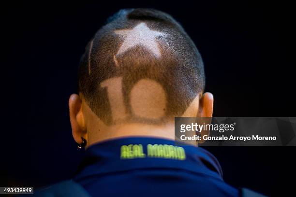 Real Madrid supporter waits with number 10 shaved on his head before starting his trip by bus to attend the UEFA Champions League Final match at...