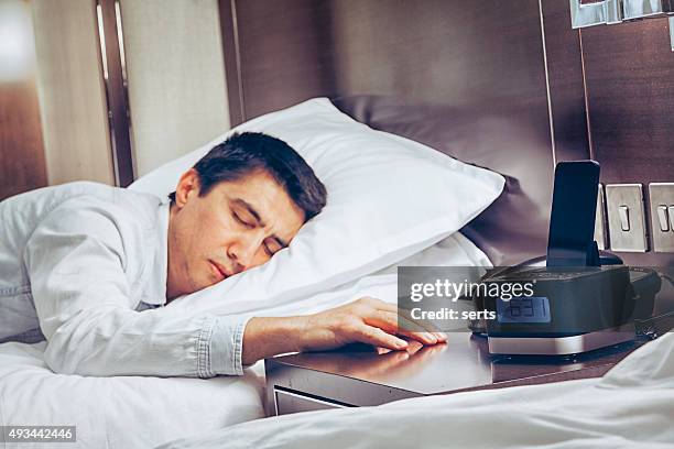 young business man zonk out and fall asleep on bed - bedroom radio stockfoto's en -beelden