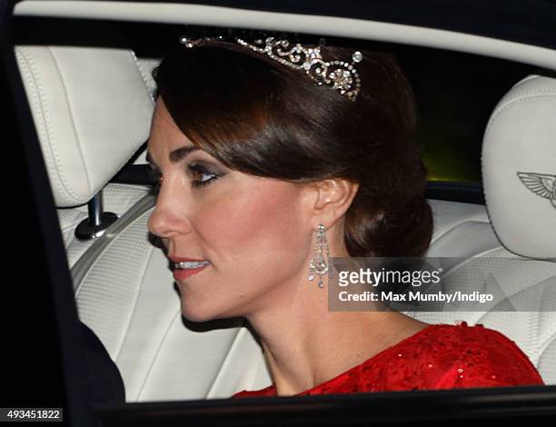 Catherine, Duchess of Cambridge arrives wearing a tiara made by Garrard London at Buckingham Palace to attend a State Banquet to honour the State...