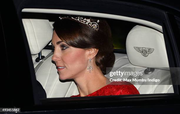 Catherine, Duchess of Cambridge arrives wearing a tiara made by Garrard London at Buckingham Palace to attend a State Banquet to honour the State...