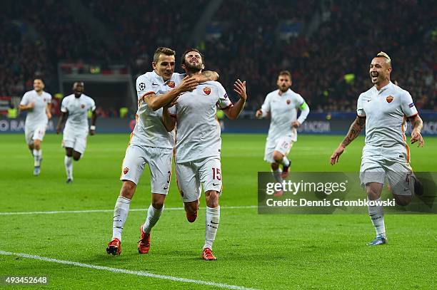 Miralem Pjanic of AS Roma celebrates with Lucas Digne and team mates as he scores their third goal during the UEFA Champions League Group E match...