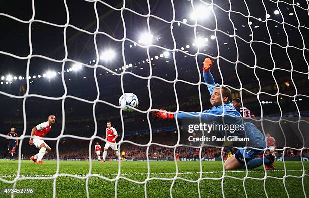 Manuel Neuer of Bayern Munich makes a save from Theo Walcott of Arsenal during the UEFA Champions League Group F match between Arsenal FC and FC...