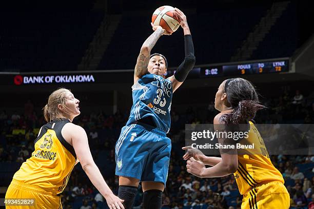Seimone Augustus of the Minnesota Lynx shoots against Theresa Plaisance and Glory Johnson of the Tulsa Shock during the WNBA game on May 23, 2014 at...