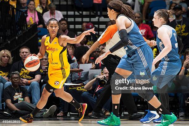 Skylar Diggins of the Tulsa Shock handles the ball and calls a play against Seimone Augustus and Lindsay Whalen of the Minnesota Lynx during the WNBA...