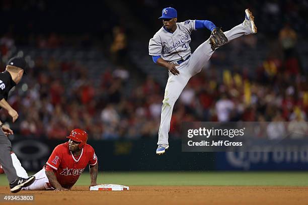 Second baseman Pedro Ciriaco of the Kansas City Royals leaps for a ball that was overthrown from the outfield in the seventh inning, as Howie...