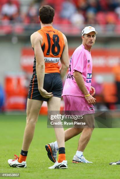 Giants runner Simon Katich delivers a message during the round 10 AFL match between the Greater Western Sydney Giants and the Richmond Tigers at...