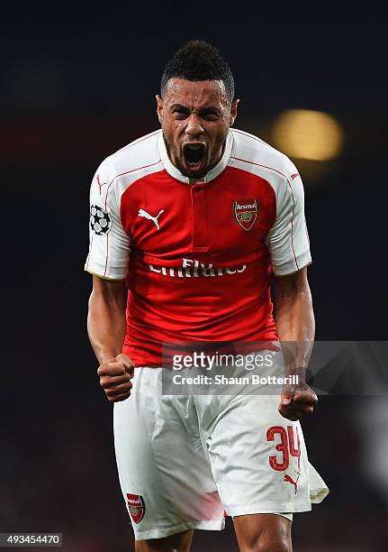 Francis Coquelin of Arsenal celebrates as Olivier Giroud scores their first goal during the UEFA Champions League Group F match between Arsenal FC...
