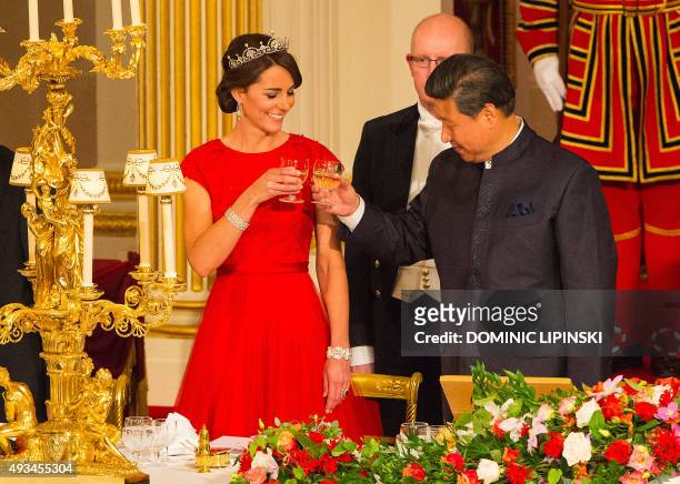Chinese President Xi Jinping raises a glass with Britain's Catherine, Duchess of Cambridge, during State Banquet hosted by Britain's Queen Elizabeth...