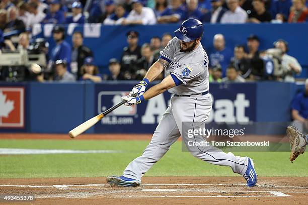 Mike Moustakas of the Kansas City Royals hits a sacrifice fly ball to score Eric Hosmer of the Kansas City Royals in the first inning against the...