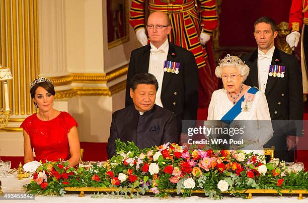 Catherine, Duchess of Cambridge and President of China Xi Jinping listen to Britain's Queen Elizabeth II speaks during a state banquet at Buckingham...