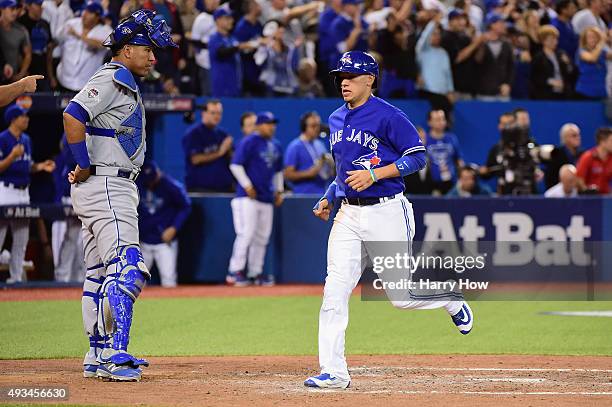 Ryan Goins of the Toronto Blue Jays scores a run in the third inning against the Kansas City Royals during game four of the American League...