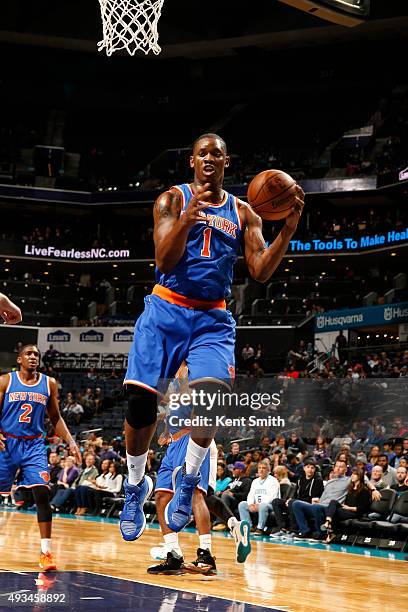 Kevin Seraphin of the New York Knicks grabs a rebound against the Charlotte Hornets during a preseason game at the Time Warner Cable Arena on October...