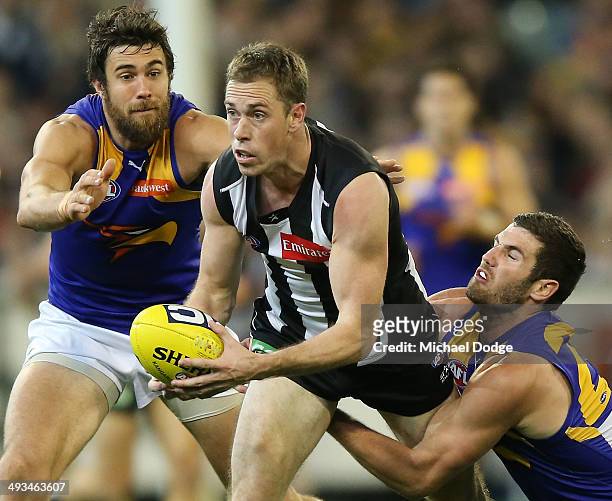 Nick Maxwell of the Magpies is tackled by Josh Kennedy Jack Darling of the Eagles during the round 10 AFL match between the Collingwood Magpies and...