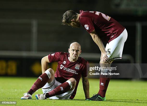 Ryan Cresswell of Northampton Town holds his hamstrig as team mate Shaun Brisley looks on during the Sky Bet League Two match between Northampton...