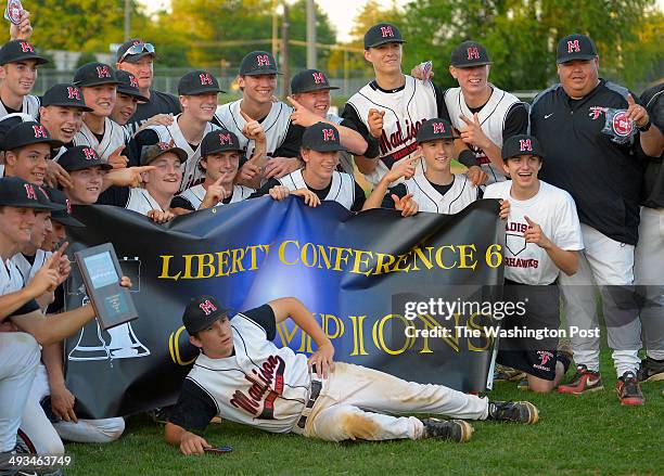 Madison players celebrate with their trophy after defeating Langley in boys baseball 3 - 0 to win the Liberty Conference finals at Madison High...