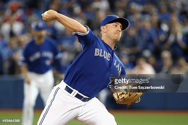 Cliff Pennington of the Toronto Blue Jays throws a pitch in the ninth inning against the Kansas City Royals during game four of the American League...