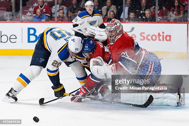 Alexander Steen of the St. Louis Blues and Andrei Markov of the Montreal Canadiens crash into goaltender Carey Price during the NHL game at the Bell...