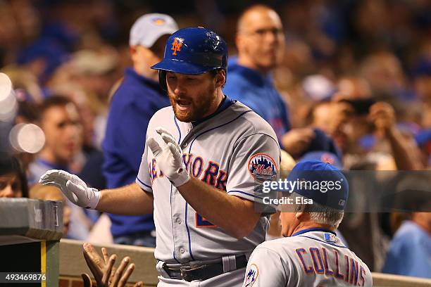 Daniel Murphy of the New York Mets celebrates with manager Terry Collins after hitting a solo home run in the third inning against Kyle Hendricks of...