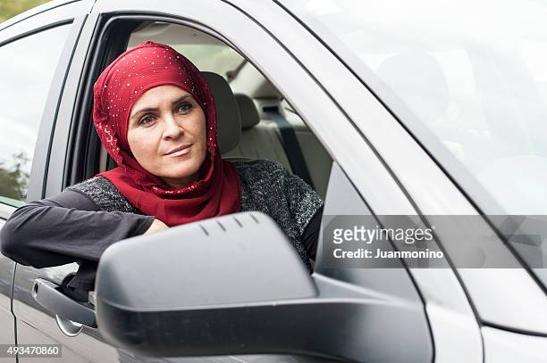 muslim woman driving - arab woman driving stock pictures, royalty-free photos & images