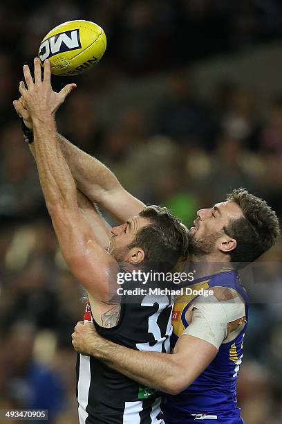 Travis Cloke of the Magpies competes for the ball against Eric Mackenzie of the Eagles during the round 10 AFL match between the Collingwood Magpies...