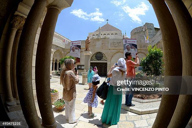 Catholic pilgrims take pictures in the courtyard of the Church of Nativity, believed to be the birth place of Jesus Christ, in the West Bank town of...