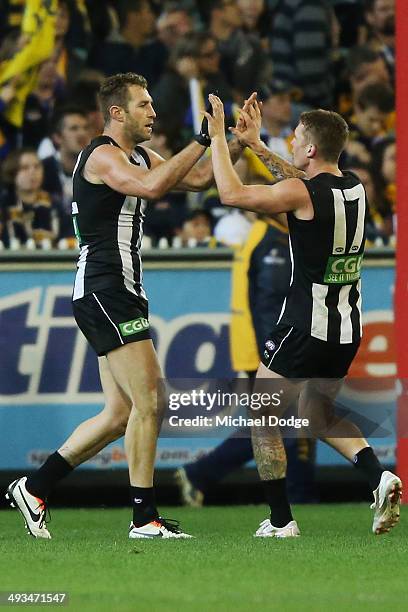 Travis Cloke of the Magpies celebrates a goal with Dayne Beams of the Magpies during the round 10 AFL match between the Collingwood Magpies and West...