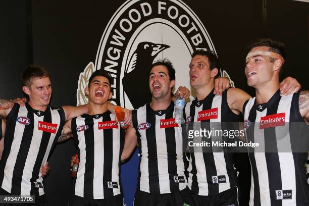 Dayne Beams, Marley Williams, Steele Sidebottom, Luke Ball and Jamie Elliott of the Magpies sing the song after winning the round 10 AFL match...