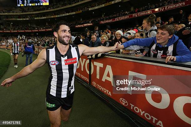 Alex Fasolo of the Magpies celebrates with fans after winning the round 10 AFL match between the Collingwood Magpies and West Coast Eagles at...