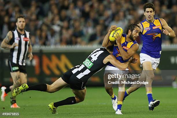 Clinton Young of the Magpies tackles Jamie Bennell of the Eagles during the round 10 AFL match between the Collingwood Magpies and West Coast Eagles...