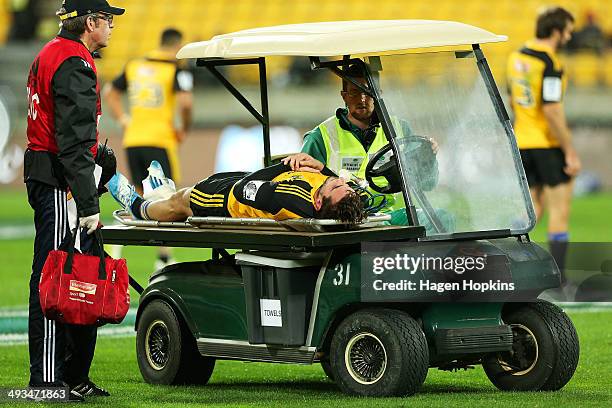 Andre Taylor of the Hurricanes is taken off the field on a stretcher after sustaining a leg injury during the round 15 Super Rugby match between the...