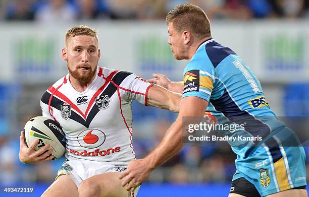 Sam Tomkins of the Warriors pushes away from the defence during the round 11 NRL match between the Gold Coast Titans and the New Zealand Warriors at...