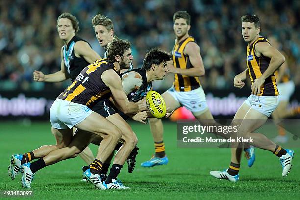 Angus Monfries of the Power is tackled by Grant Birchall of the Hawks during the round 10 AFL match between the Port Adelaide Power and the Hawthorn...