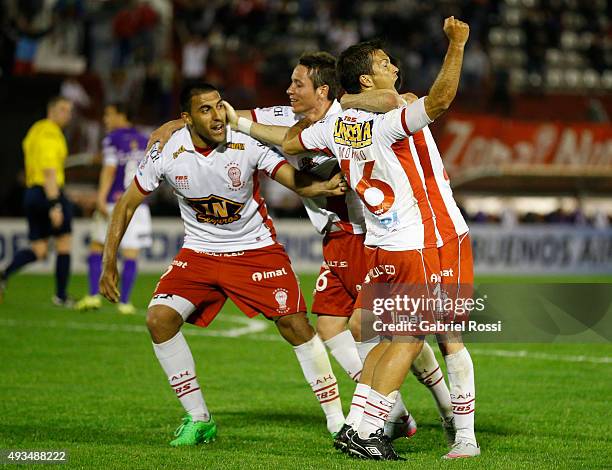 Ramon Abila of Huracan celebrates with teammates after scoring the opening goal during a match between Huracan and Defensor Sporting as part of...