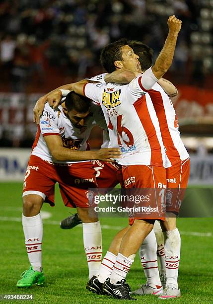 Ramon Abila of Huracan celebrates with teammates after scoring the opening goal during a match between Huracan and Defensor Sporting as part of...