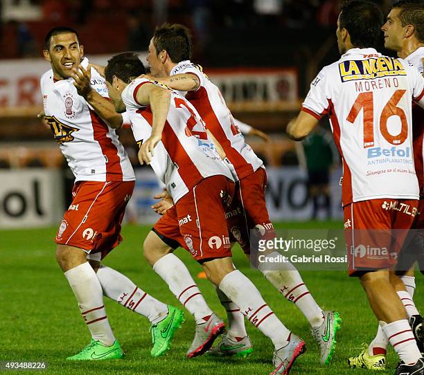 Ramon Abila of Huracan celebrates with teammates after scoring the opening goal during a match between Huracan and Defensor Sporting as part of...