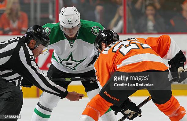 Linesman Jay Sharrers prepares to drop the puck for a faceoff between Scott Laughton of the Philadelphia Flyers and Cody Eakin of the Dallas Stars in...