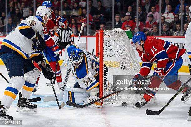 Brendan Gallagher of the Montreal Canadiens tries to get the puck near the net of goaltender Jake Allen of the St. Louis Blues during the NHL game at...