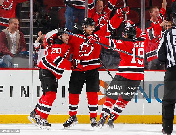 Adam Larsson of the New Jersey Devils is congratulated after scoring the game winning goal in overtime against the Arizona Coyotes at the Prudential...