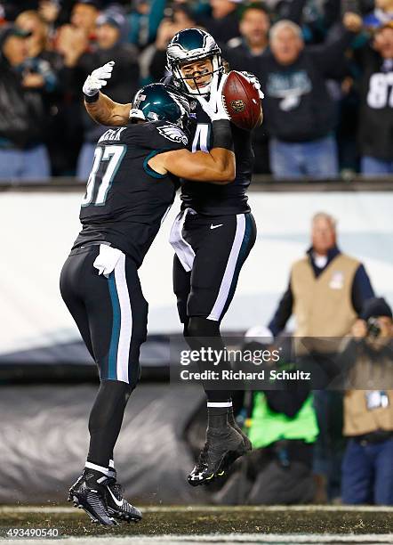 Riley Cooper of the Philadelphia Eagles is congratulated by his teammate Brent Celek after scoring a first quarter touchdown against the New York...