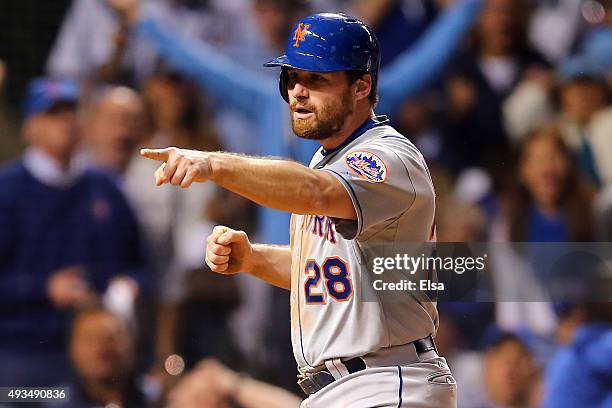 Daniel Murphy of the New York Mets celebrates after scoring off of an RBI ground out hit by Lucas Duda in the seventh inning against Justin Grimm of...