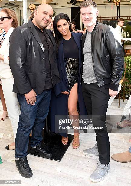 Personality Kim Kardashian poses with CADET's Raul Arevalo and Brad Schmidt at CFDA/Vogue Fashion Fund Show and Tea at Chateau Marmont on October 20,...