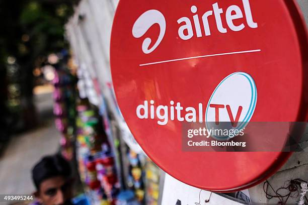 An advertisement for Bharti Airtel Ltd. Is displayed outside a store in Mumbai, India, on Monday, Oct. 19, 2015. Bharti, Indias largest wireless...