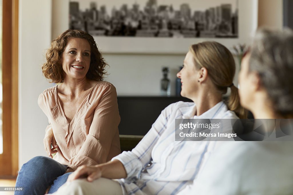 Woman conversing with friends at home