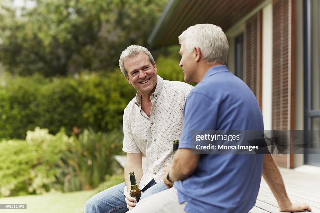 Friends with beer bottles spending leisure time