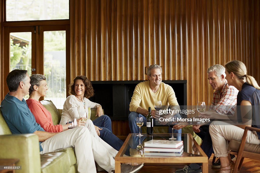 Mature friends having wine at home