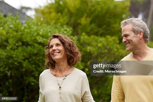 couple walking in park - brown hair stock pictures, royalty-free photos & images