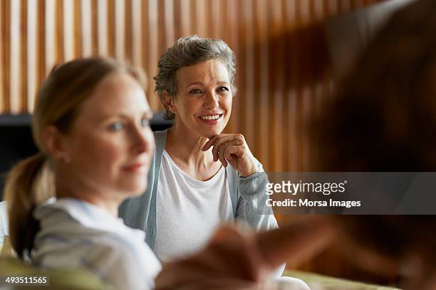 women spending leisure time at home - mature women talking stock pictures, royalty-free photos & images