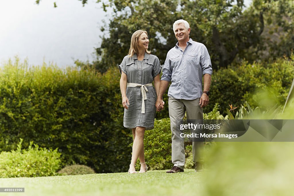 Happy couple walking in park