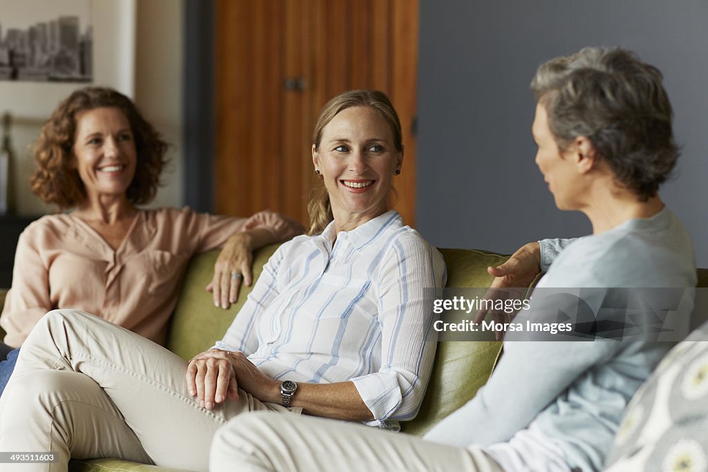 Women conversing in living room